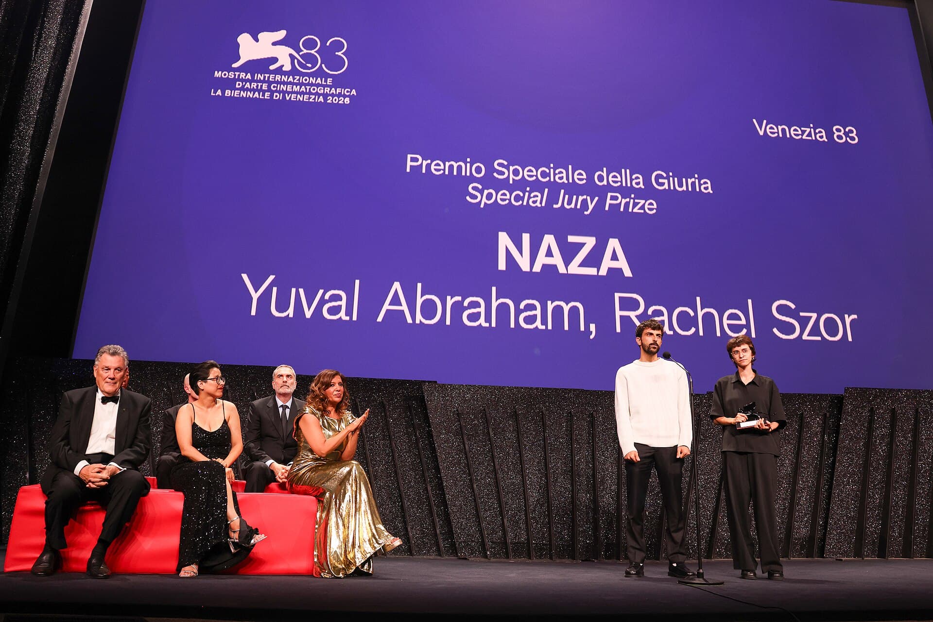 Yuval Abraham and Rachel Szor on stage at the Venice Film Festival closing ceremony, receiving the Special Jury Prize for NAZA